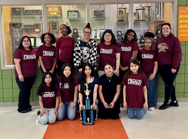  group of girls posing with trophy